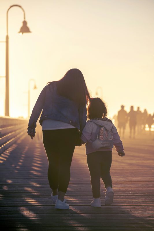 Mother and daughter walking together towards the future